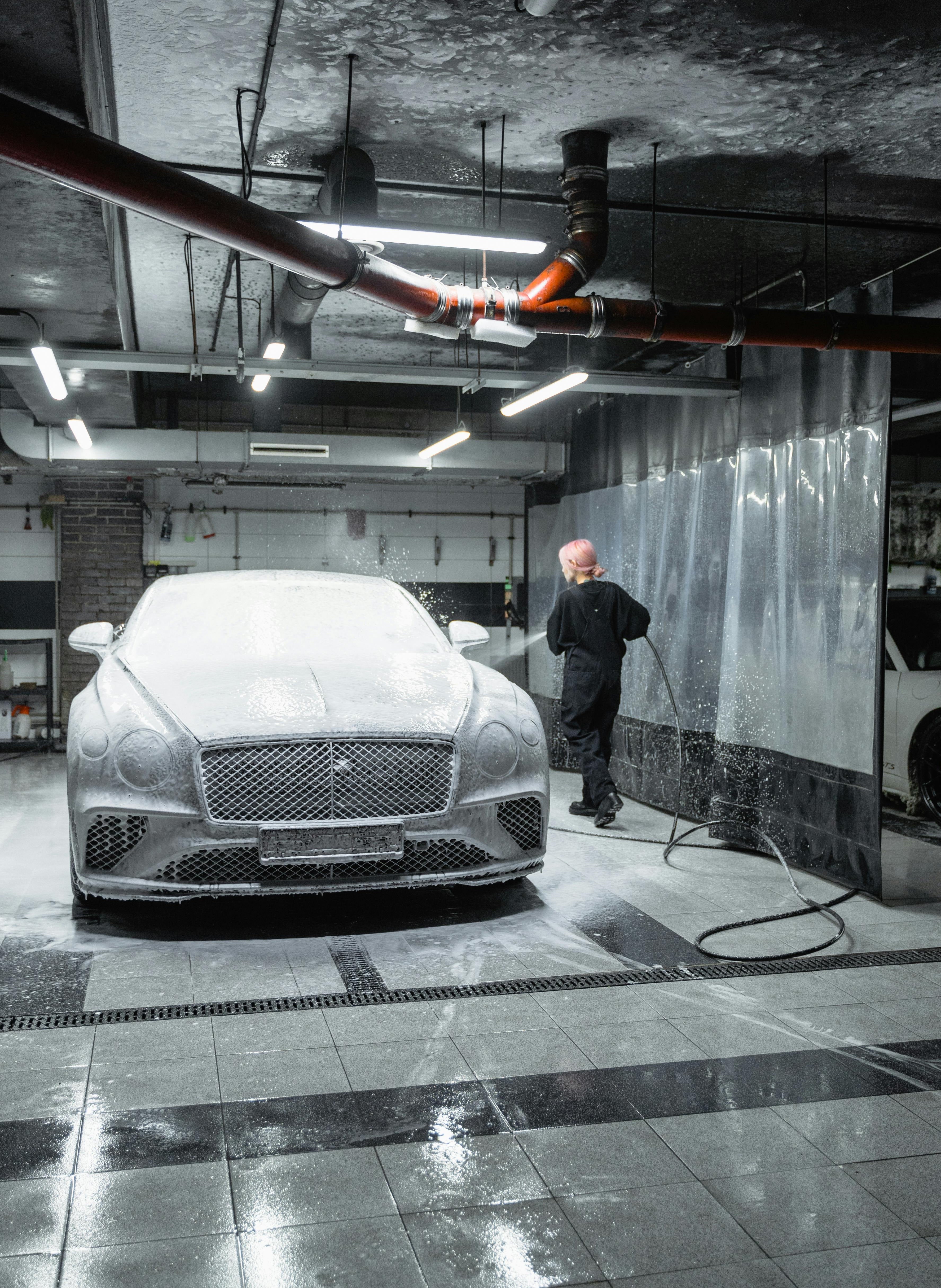 A woman detailing her car for a showroom finish.