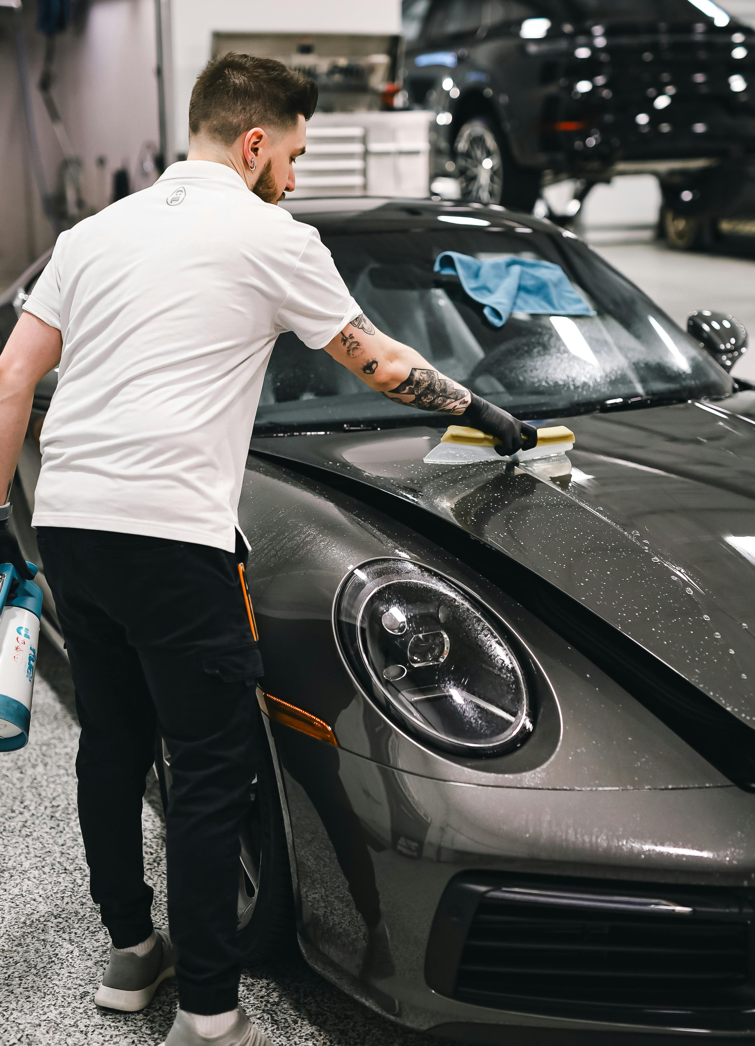 A man detailing his car for a showroom finish.